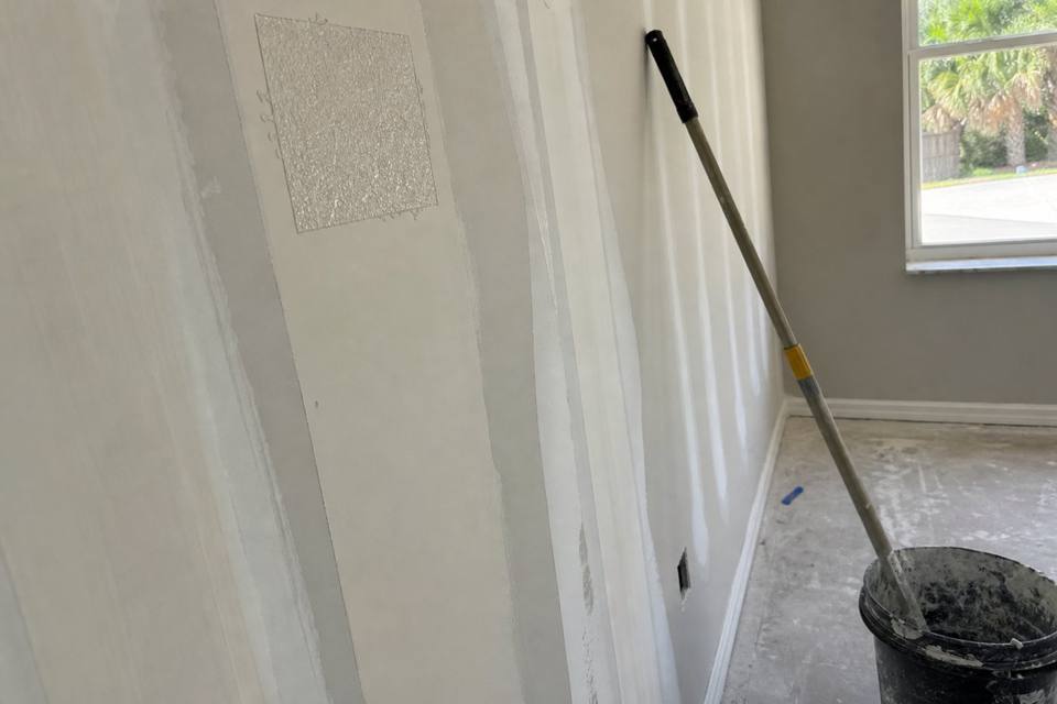 Taped seams and joint compound during drywall finishing for Brevard County drywall projects